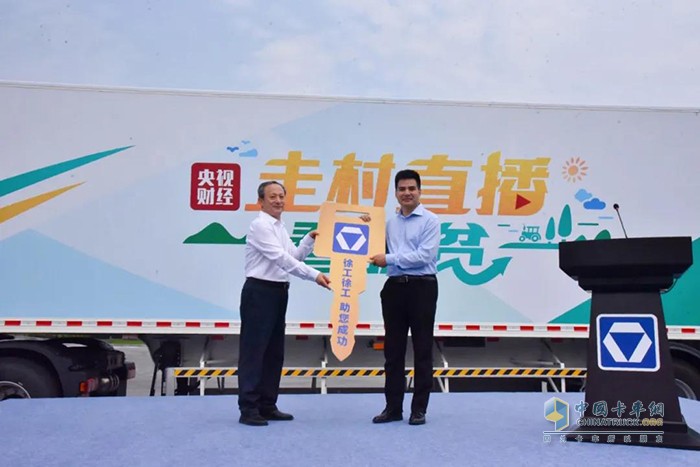 徐工集團(tuán)工程機(jī)械有限公司黨委書記、董事長王民向中央廣播電視總臺央視財經(jīng)頻道副總監(jiān)陳永慶交接大篷車鑰匙